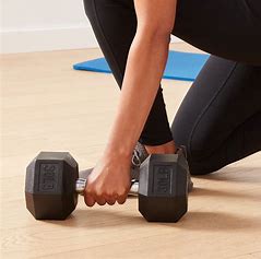 Two black dumbbells placed side by side on a gym floor, symbolizing strength training and fitness|healthymap.in